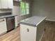 Kitchen island features granite countertop, and a stainless steel dishwasher nearby at 1871 Kinridge Rd, Marietta, GA 30062