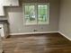 Bright kitchen area with wood-look flooring and view of backyard at 1871 Kinridge Rd, Marietta, GA 30062