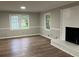 Bright living room features wood floors, a fireplace, and two large windows at 1871 Kinridge Rd, Marietta, GA 30062