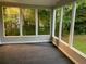 Sunroom with windows overlooking wooded yard at 1871 Kinridge Rd, Marietta, GA 30062