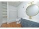 Bright bathroom featuring a shower-tub combo, modern vanity and wood grain floors at 20 Marietta St # 4B, Atlanta, GA 30303
