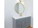 Modern bathroom featuring a round mirror, white countertop, and gray vanity at 20 Marietta St # 4B, Atlanta, GA 30303
