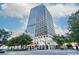 Beautiful high-rise building with green trees and some passing traffic at 20 Marietta St # 4B, Atlanta, GA 30303