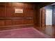 Hallway with dark wood paneling, purple carpet and decorative art at 20 Marietta St # 4B, Atlanta, GA 30303