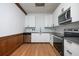 Modern kitchen features white cabinets, stainless steel appliances, and a sleek subway tile backsplash at 20 Marietta St # 4B, Atlanta, GA 30303