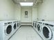 Clean and organized communal laundry room with multiple washing machines at 20 Marietta St # 4B, Atlanta, GA 30303