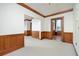 Large living room with neutral carpet, wood trim, and multiple doorways at 20 Marietta St # 4B, Atlanta, GA 30303