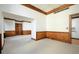 Open living room featuring neutral carpet, wood trim, and connection to a kitchen area at 20 Marietta St # 4B, Atlanta, GA 30303