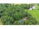 Overhead shot of a home near a pond and open fields, surrounded by a dense tree line at 527 Gaddis Rd, Canton, GA 30115