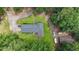 Overhead view of a home with outbuildings, driveway, and surrounding wooded area offering seclusion at 527 Gaddis Rd, Canton, GA 30115
