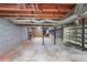 Unfinished basement with exposed ductwork, brick walls, and concrete floor at 527 Gaddis Rd, Canton, GA 30115