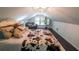 Attic bedroom with hardwood floors, lots of pillows, and unique charm at 527 Gaddis Rd, Canton, GA 30115
