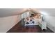 Attic bedroom with hardwood floors, sloped ceiling, and bright window at 527 Gaddis Rd, Canton, GA 30115