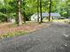 Charming home with a blue door, surrounded by lush trees and a long driveway at 527 Gaddis Rd, Canton, GA 30115