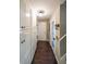 Hallway features hardwood floors, storage cabinets, and a white door at the end at 527 Gaddis Rd, Canton, GA 30115