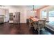 Bright kitchen and dining area with stainless steel appliances, white cabinets, and hardwood floors at 527 Gaddis Rd, Canton, GA 30115