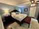 Comfortable main bedroom features an area rug, blue walls, and decorative bedside lighting at 527 Gaddis Rd, Canton, GA 30115