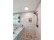 Walk-in shower with pebble floor, tiled walls, and built in shelf at 527 Gaddis Rd, Canton, GA 30115