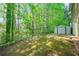 Secluded backyard with mature landscaping and shed at 610 Durham Ridge Nw Dr, Lilburn, GA 30047