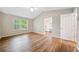 Bedroom showcasing wood floors, a large window, and access to the ensuite bathroom with dual vanity at 610 Durham Ridge Nw Dr, Lilburn, GA 30047