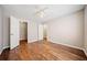 A cozy bedroom with hardwood floors, a ceiling fan, and an open closet at 610 Durham Ridge Nw Dr, Lilburn, GA 30047
