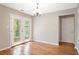 Dining area featuring wood floors, light fixture, and french doors leading to the backyard area at 610 Durham Ridge Nw Dr, Lilburn, GA 30047