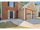 Inviting brick home featuring a two-car garage and classic front door at 610 Durham Ridge Nw Dr, Lilburn, GA 30047