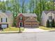 Two-story home featuring a brick and brown exterior, two car garage and landscaped front yard at 610 Durham Ridge Nw Dr, Lilburn, GA 30047