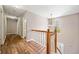 Charming upstairs hallway with wood floors and a staircase featuring an elegant window allowing natural light at 610 Durham Ridge Nw Dr, Lilburn, GA 30047