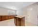 Functional kitchen featuring custom cabinets, tile floors, center island, and countertop space at 610 Durham Ridge Nw Dr, Lilburn, GA 30047