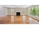 Bright living room features wood flooring, fireplace, and large windows that let in plenty of natural light at 610 Durham Ridge Nw Dr, Lilburn, GA 30047