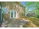 Back patio of home with green lawn and mature trees in background at 610 Durham Ridge Nw Dr, Lilburn, GA 30047
