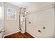 Compact utility area with water heater, shelving and window providing natural light at 610 Durham Ridge Nw Dr, Lilburn, GA 30047