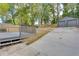 A backyard view showing a deck, a fenced yard, a detached garage, and a concrete walkway at 1705 Ezra Church Nw Dr, Atlanta, GA 30314