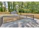 A serene backyard featuring a deck, a fenced yard, and a detached two-car garage at 1705 Ezra Church Nw Dr, Atlanta, GA 30314