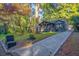 Landscaped front yard with an exposed aggregate driveway leading up to the home at 1705 Ezra Church Nw Dr, Atlanta, GA 30314