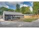 A beautifully renovated home featuring a modern exterior, lush lawn, and a wooden deck at 1705 Ezra Church Nw Dr, Atlanta, GA 30314
