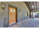 Cozy front porch featuring a brick wall, stained front door and modern lighting at 1705 Ezra Church Nw Dr, Atlanta, GA 30314