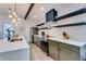 Stylish kitchen with quartz countertops, floating shelves, and stainless steel appliances at 1705 Ezra Church Nw Dr, Atlanta, GA 30314
