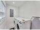 Bright laundry room featuring a modern washer and dryer, and stylish tile flooring at 1705 Ezra Church Nw Dr, Atlanta, GA 30314