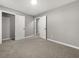 A spacious bedroom featuring neutral carpeting, gray walls, and crisp white doors at 1971 Westley Dr, Riverdale, GA 30296