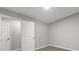 Cozy bedroom featuring soft neutral carpeting, freshly painted gray walls, and crisp white doors at 1971 Westley Dr, Riverdale, GA 30296