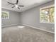 A serene bedroom with neutral carpet, gray walls, and a modern ceiling fan for added comfort at 1971 Westley Dr, Riverdale, GA 30296