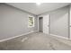 Inviting bedroom with soft neutral carpeting, gray walls, and a window offering natural light and a view at 1971 Westley Dr, Riverdale, GA 30296