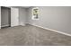 Bedroom featuring soft carpeting, gray walls, a window, and an open door at 1971 Westley Dr, Riverdale, GA 30296