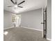 A comfortable bedroom with soft carpeting, gray walls, and a modern ceiling fan for airflow at 1971 Westley Dr, Riverdale, GA 30296