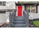 Welcoming entryway featuring a vibrant red door, gray steps, and a freshly landscaped yard at 1971 Westley Dr, Riverdale, GA 30296