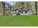 Charming two-story home boasts a white exterior, black trim, inviting red door, and a spacious green lawn at 1971 Westley Dr, Riverdale, GA 30296