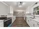 Open kitchen with new appliances, white cabinets, and updated countertops at 1971 Westley Dr, Riverdale, GA 30296