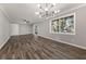 Bright living room featuring wood floors, neutral paint, a modern light fixture, and a large window with natural light at 1971 Westley Dr, Riverdale, GA 30296